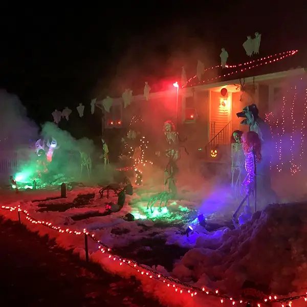 Front of a house at night decorated for Halloween