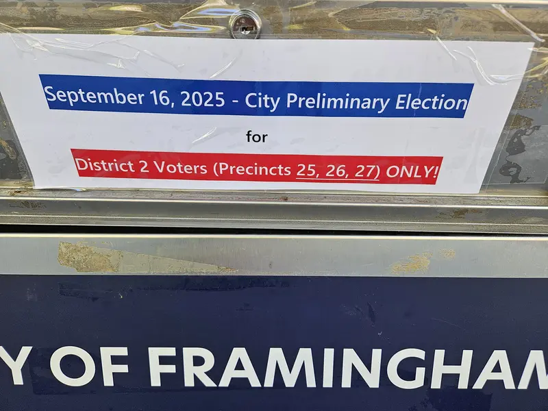 Photo of the ballot drop box slot saying push and info that this is for District 2 preliminary ballots in precincts 25, 26, and 27 only